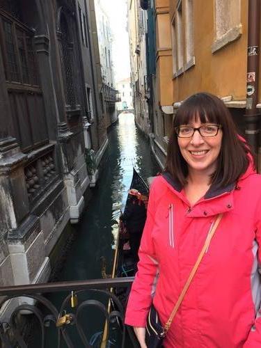 Holly Henrickson in Venice, Italy on a bridge over a canal